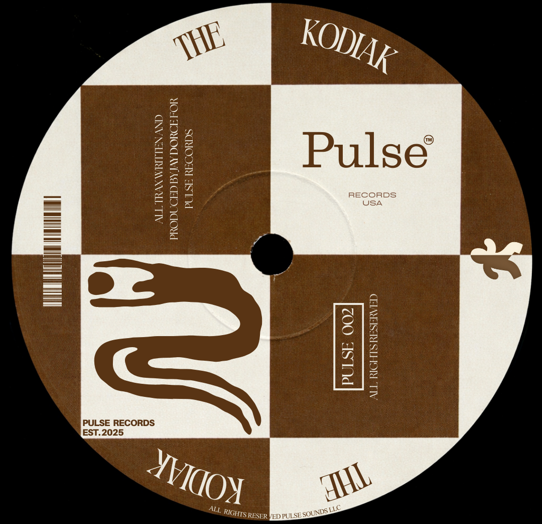 A record label featuring a checkerboard pattern with brown and beige squares, displaying the words 'The Kodak' and 'Pulse', along with a stylized snake illustration, barcode, and various text elements.