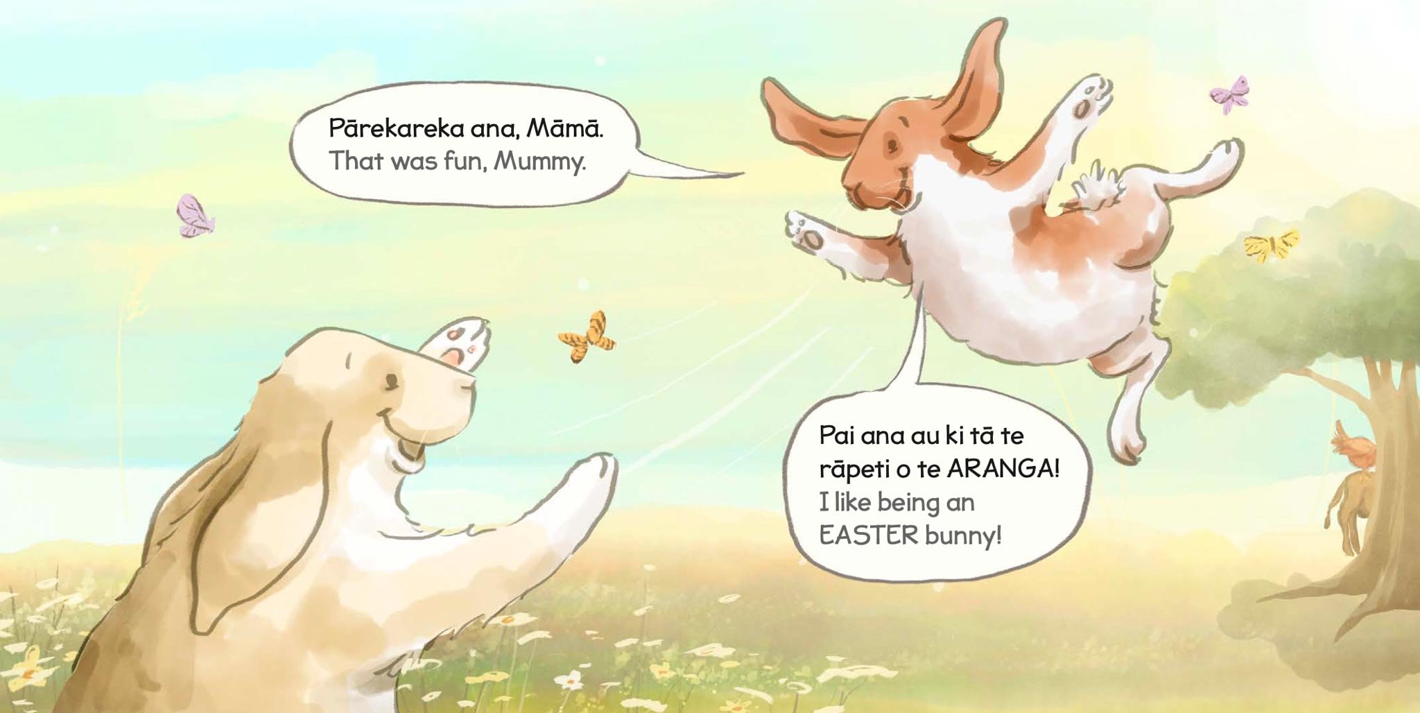 Illustration of two dogs in a springtime field with pastel colors, butterflies, and a tree. One dog is jumping high with a speech bubble saying, 'Pārekareka ana, Māma. That was fun, Mummy.' The other dog is sitting with a speech bubble that says, 'Pa