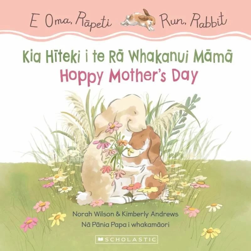 Book cover with illustrations of a mother dog and her puppy hugging each other in a grassy field surrounded by colorful flowers. Text in Māori and English wishing a Happy Mother's Day.