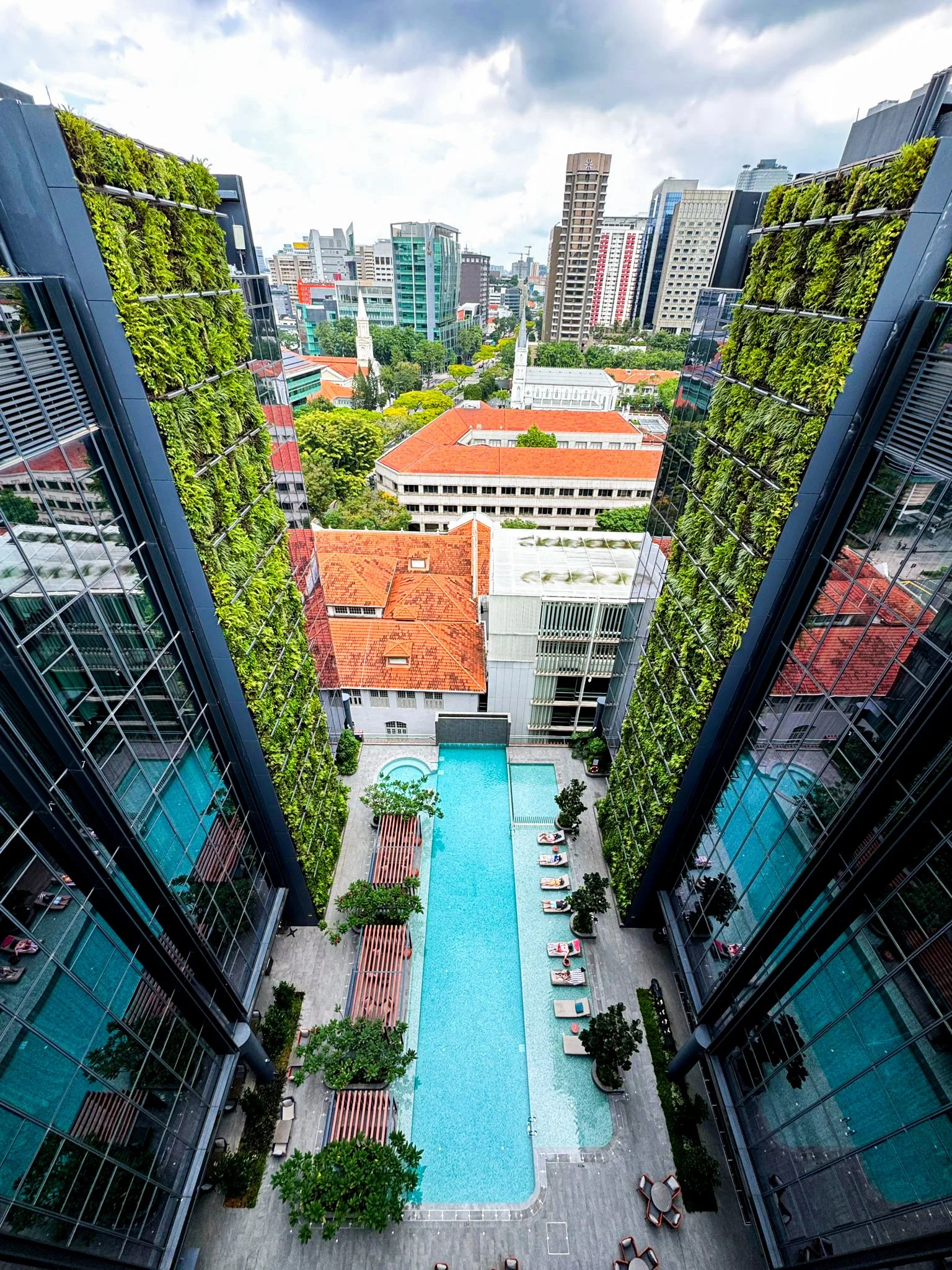 A view of 2 green walls on the facade of the building