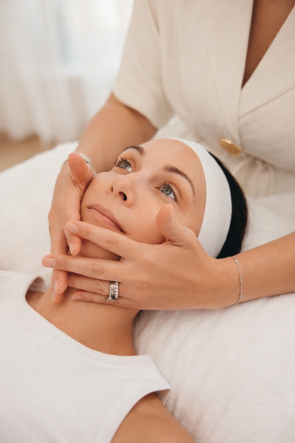 A woman receiving a facial treatment from a skincare professional.