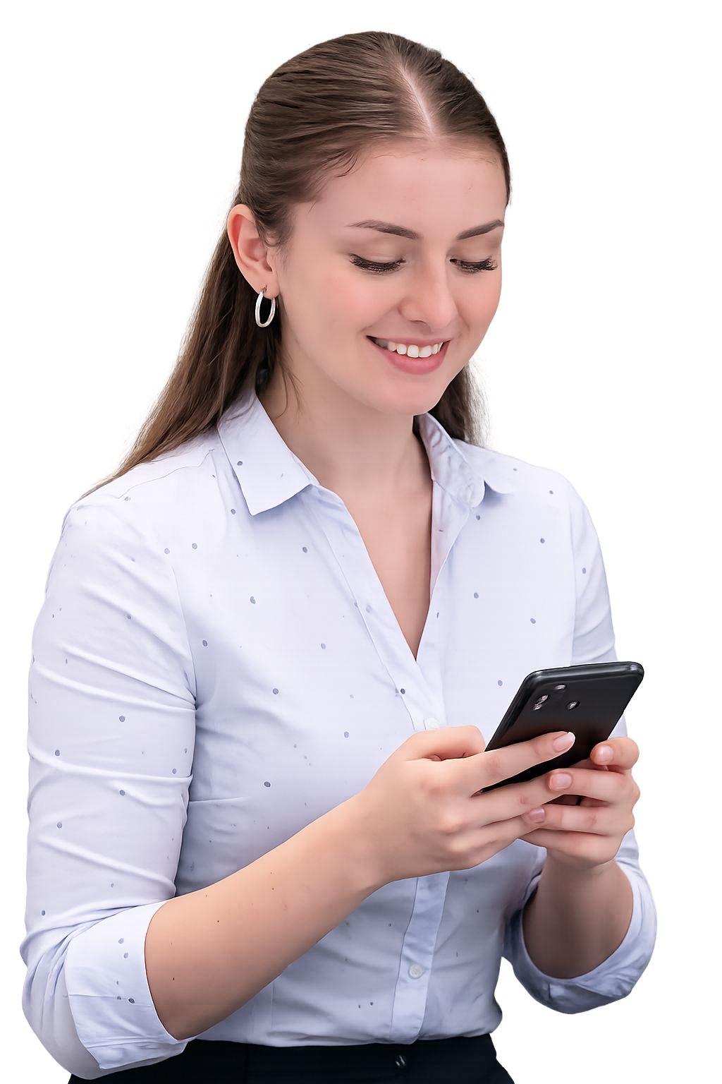 A young woman with long hair wearing a white blouse with small polka dots, smiling while looking at her smartphone.