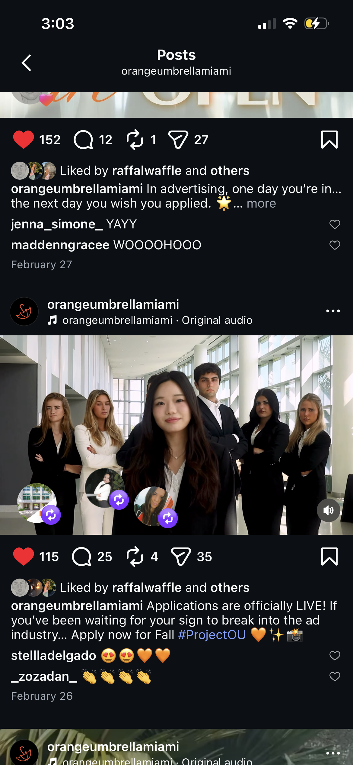 Group of six diverse young professionals, four women and two men, dressed in business attire, standing in a modern, glass-fronted building.