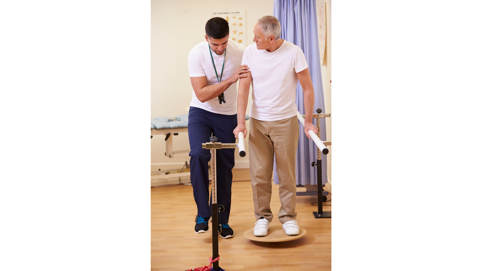 A healthcare professional assisting a patient with a physical therapy exercise using parallel bars and a balance board in a clinical setting.
