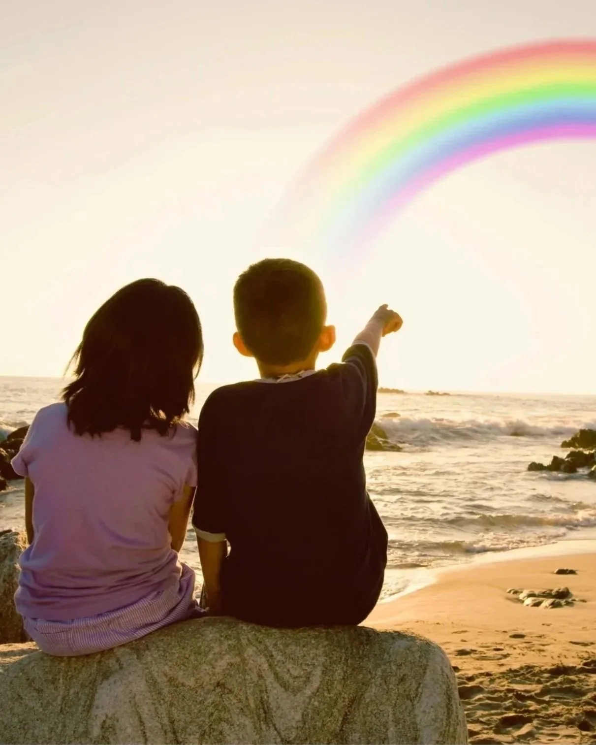 Boy and girl looking at rainbow