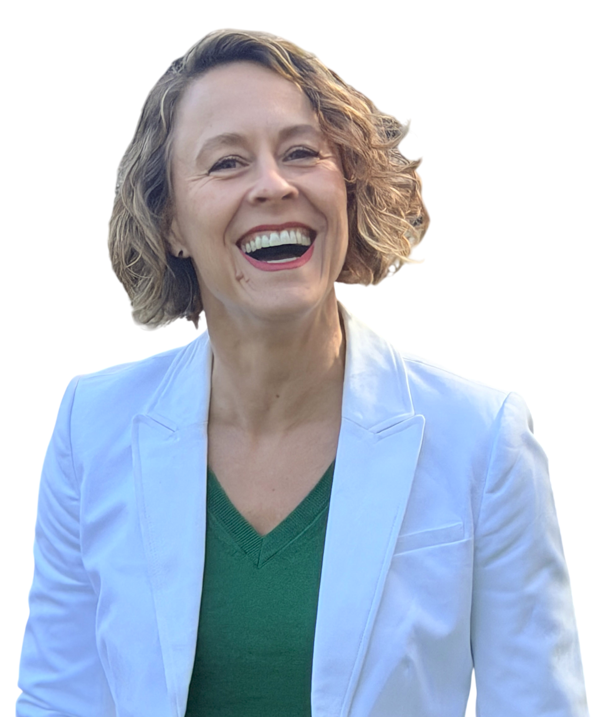 A woman with curly short hair, wearing a white blazer and green V-neck top, smiling brightly.