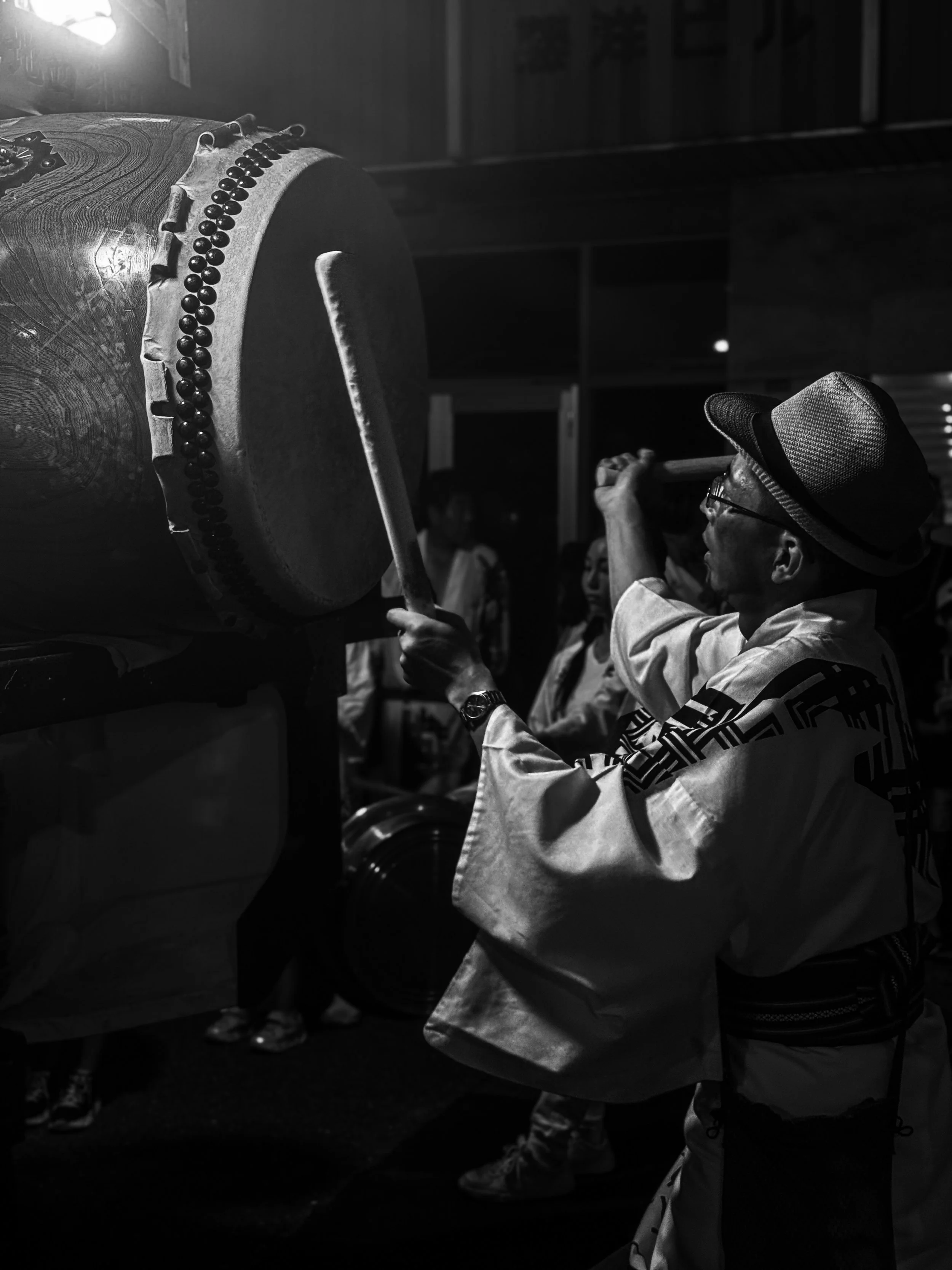 Taiko performer during a matsuri in Aichi, Japan, photographed in black and white.