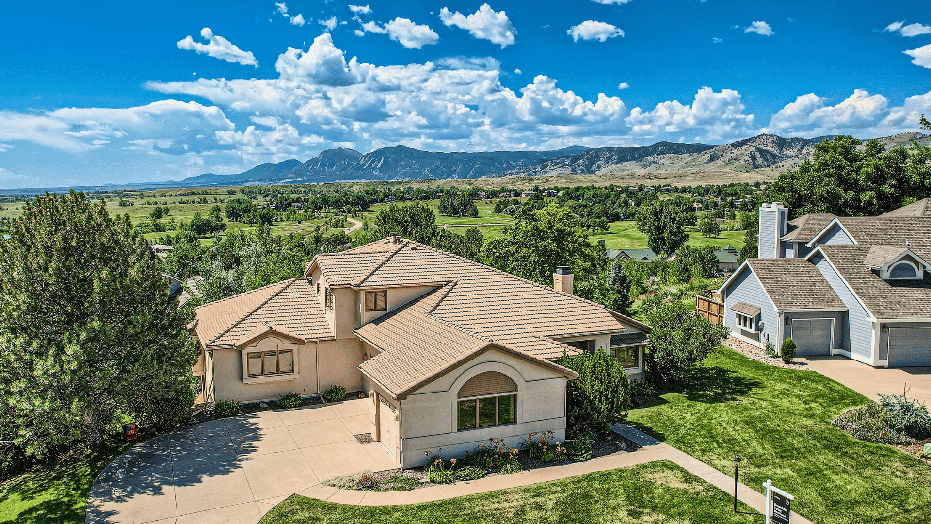Single story home aerial view blue sky background
