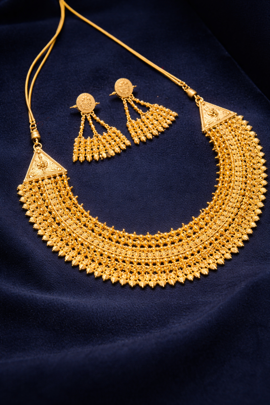 Elegant gold jewelry set on velvet.png