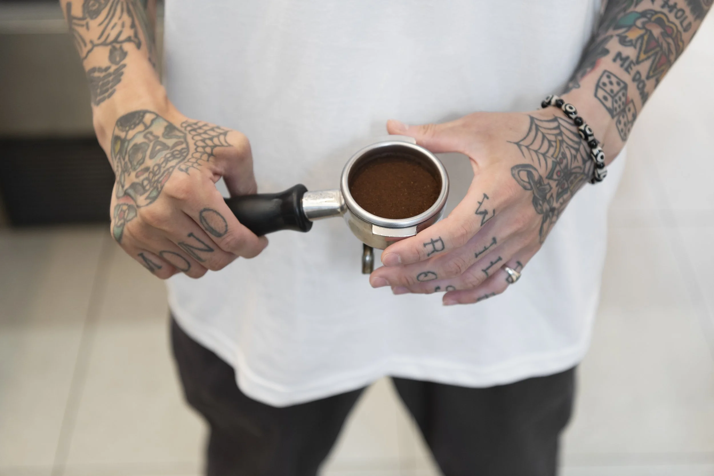 male-barista-with-tattoos-preparing-coffee-coffee-machine.jpg