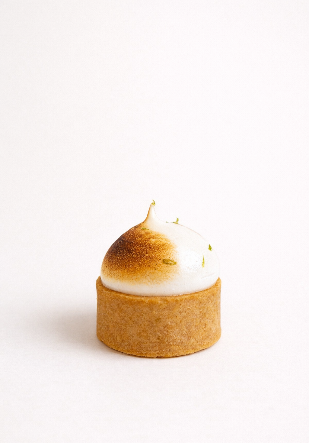 Handcrafted yuzu meringue tart petit four topped with a perfectly torched meringue peak and fresh zest. Premium dessert delivery in Sydney.