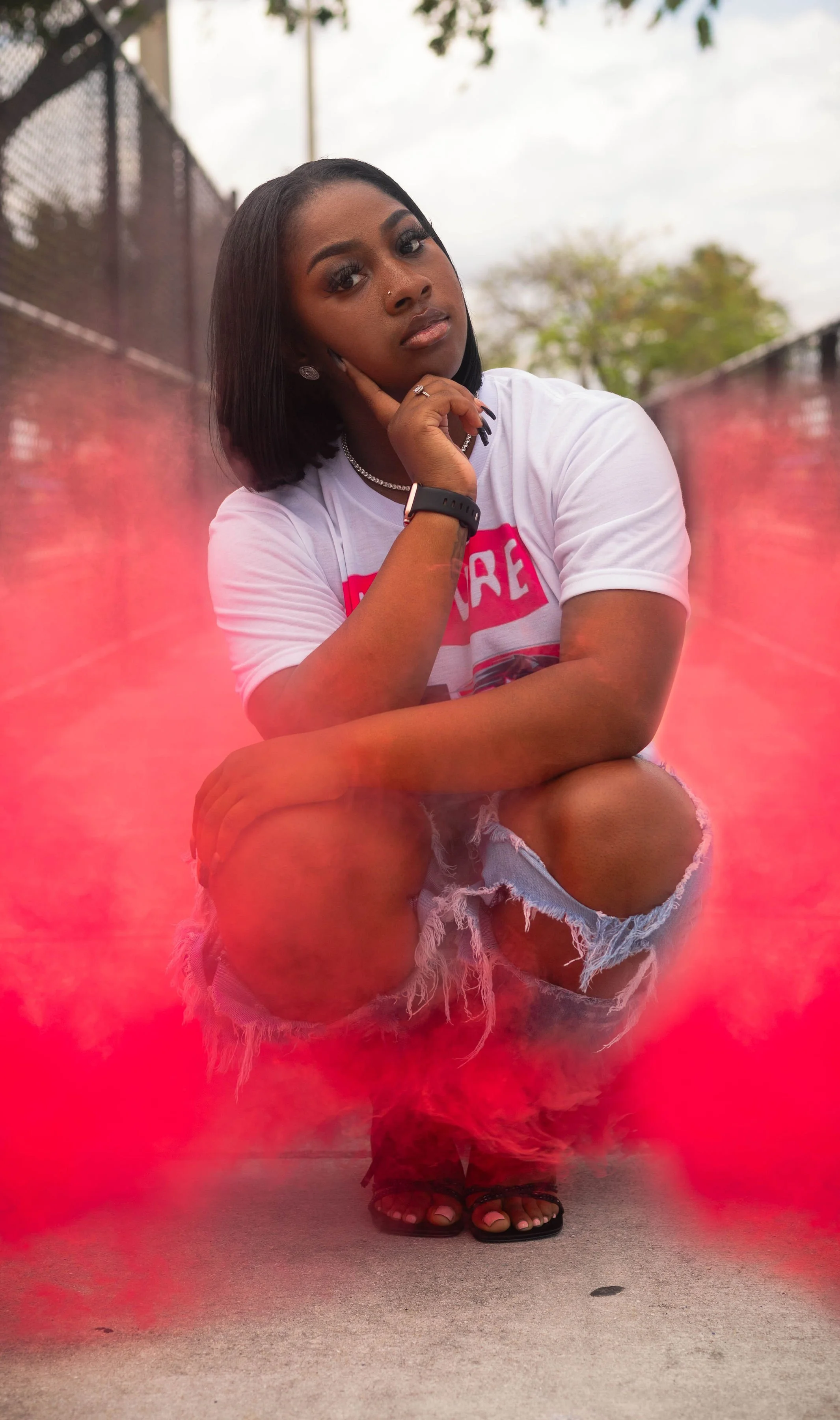 A young woman taking a picture for a graduation photo shoot