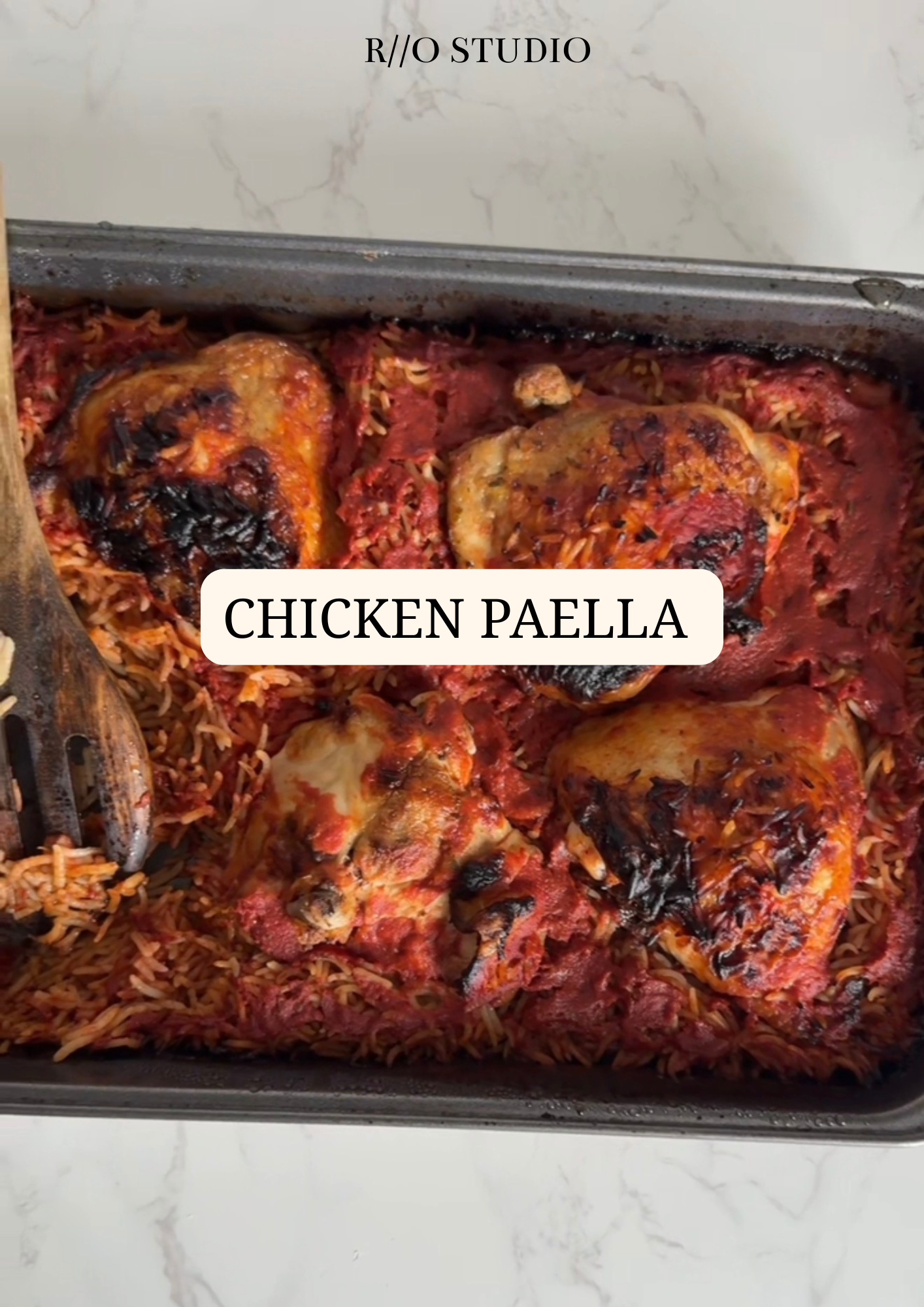 Chicken paella served with rice and tomatoes 