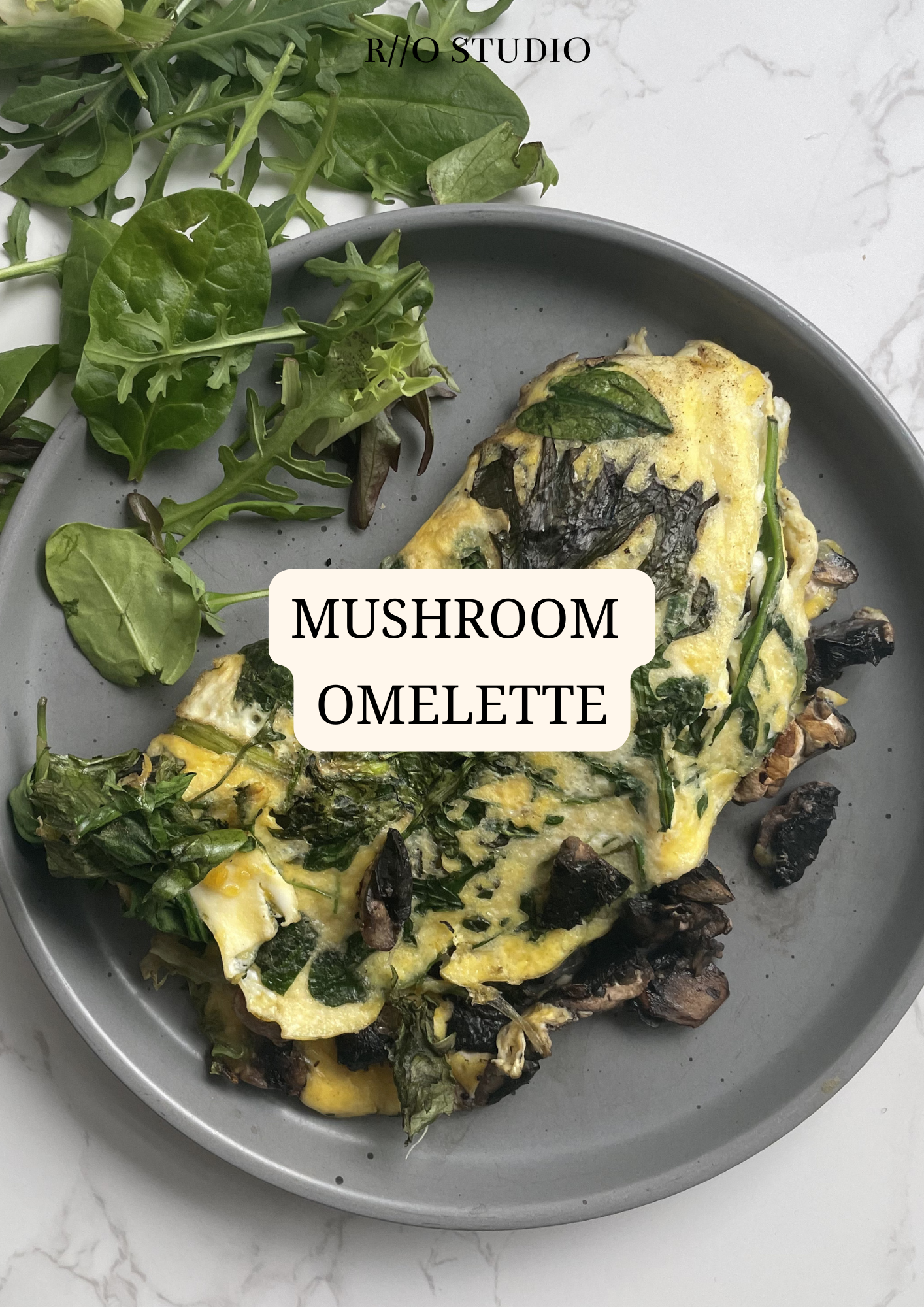 A mushroom omelette served with a side of toasted bread or spinach