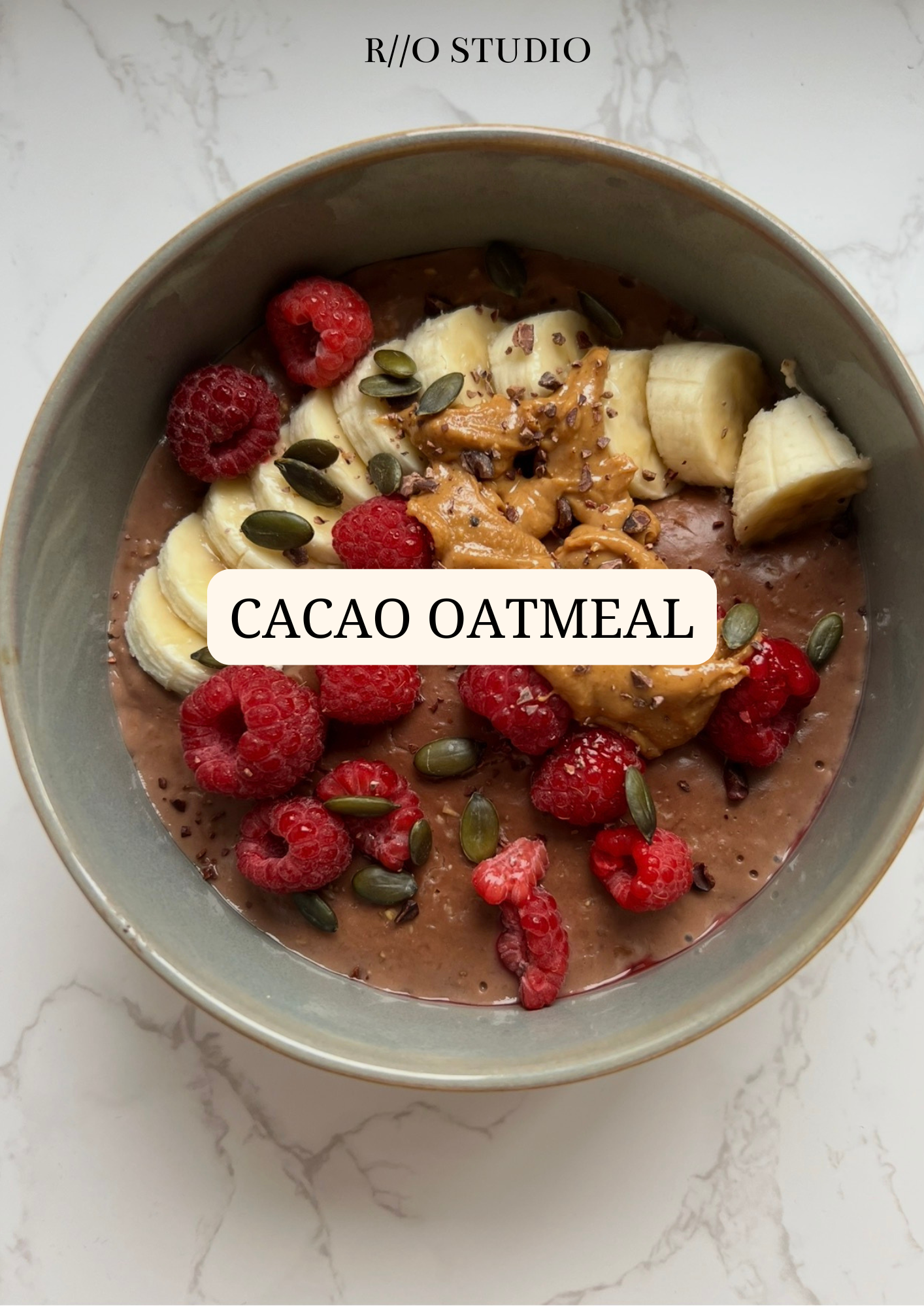 A bowl of cacao filled oatmeal topped with banana slices, pumpkin seeds and berries sprinkled with cinnamon and himalayan sea salt 