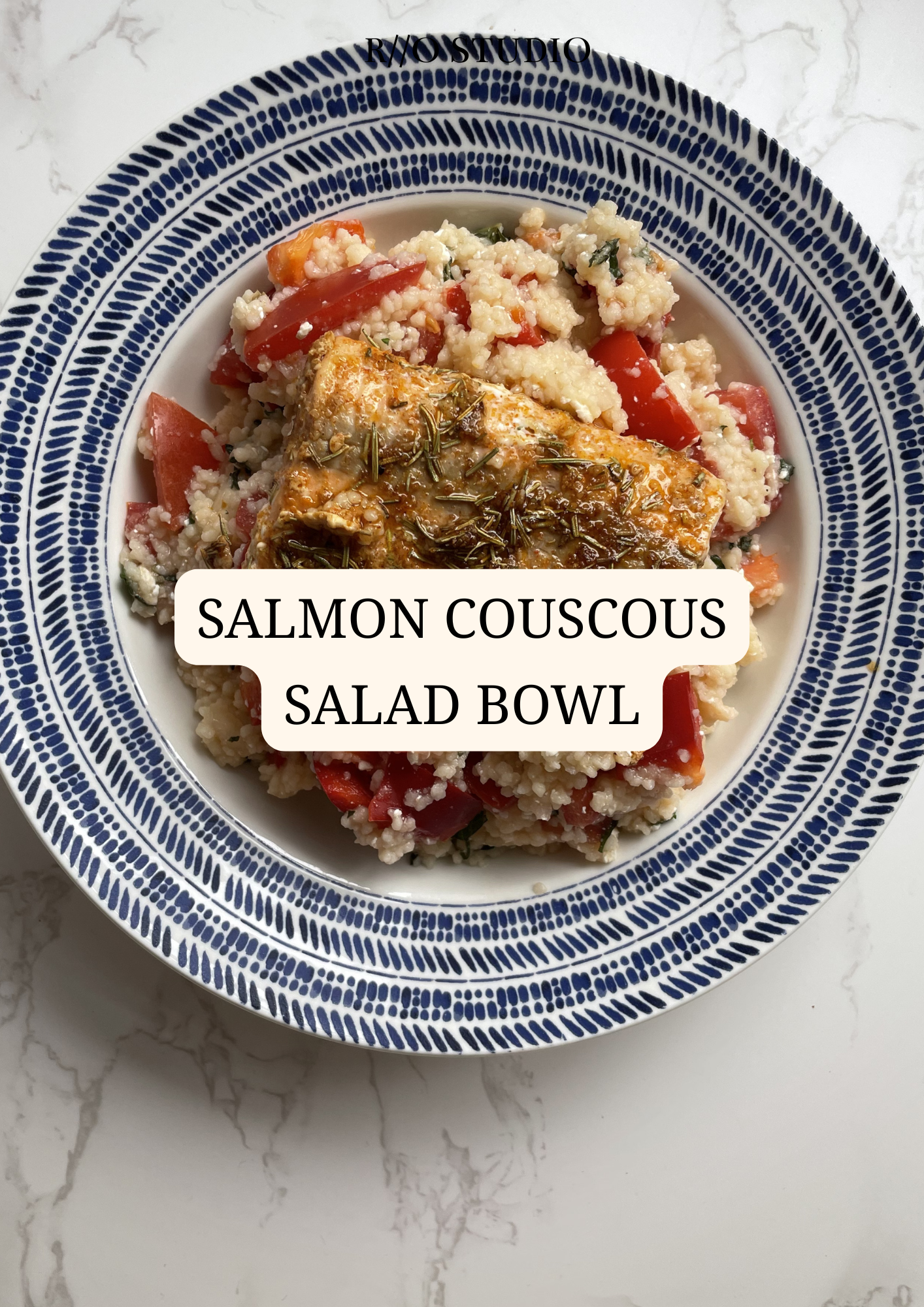 Salmon couscous bowl with chopped tomatoes and cucumber crumbled and sprinkled with fresh mint and feta cheese 