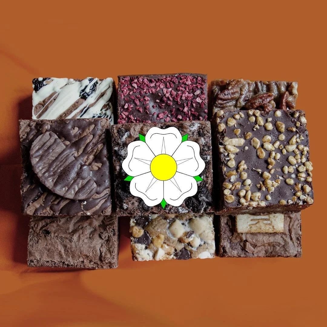 Assorted pieces of chocolate fudge with different toppings on a brown background, arranged in a 3x3 grid with a white floral graphic overlaid in the center.