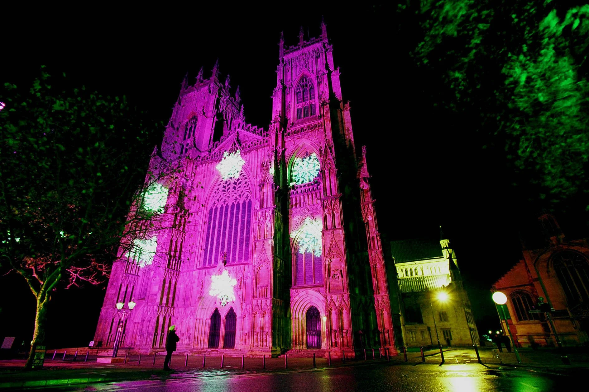 The very first ever coloured lighting display on York Minster, illuminated in purple with white snowflakes.