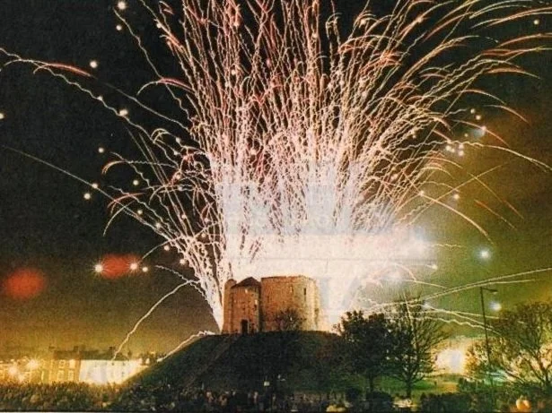 Fireworks exploding above Clifford's Tower a 13th-century stone keep standing on a high conical mound in York city centre.