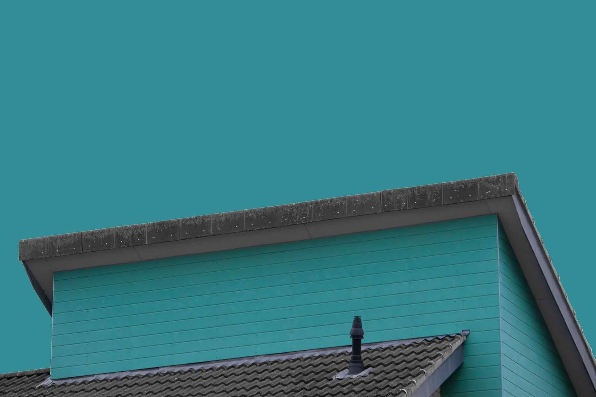 Close-up of a teal-colored house with a gabled roof, black chimney, and a chimney cap, set against a teal sky background.