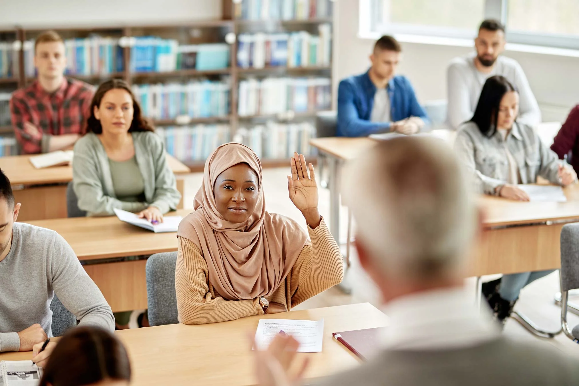 NADSN | National Association of Disabled Staff Networks | Woman Raising Her Hand in a Class