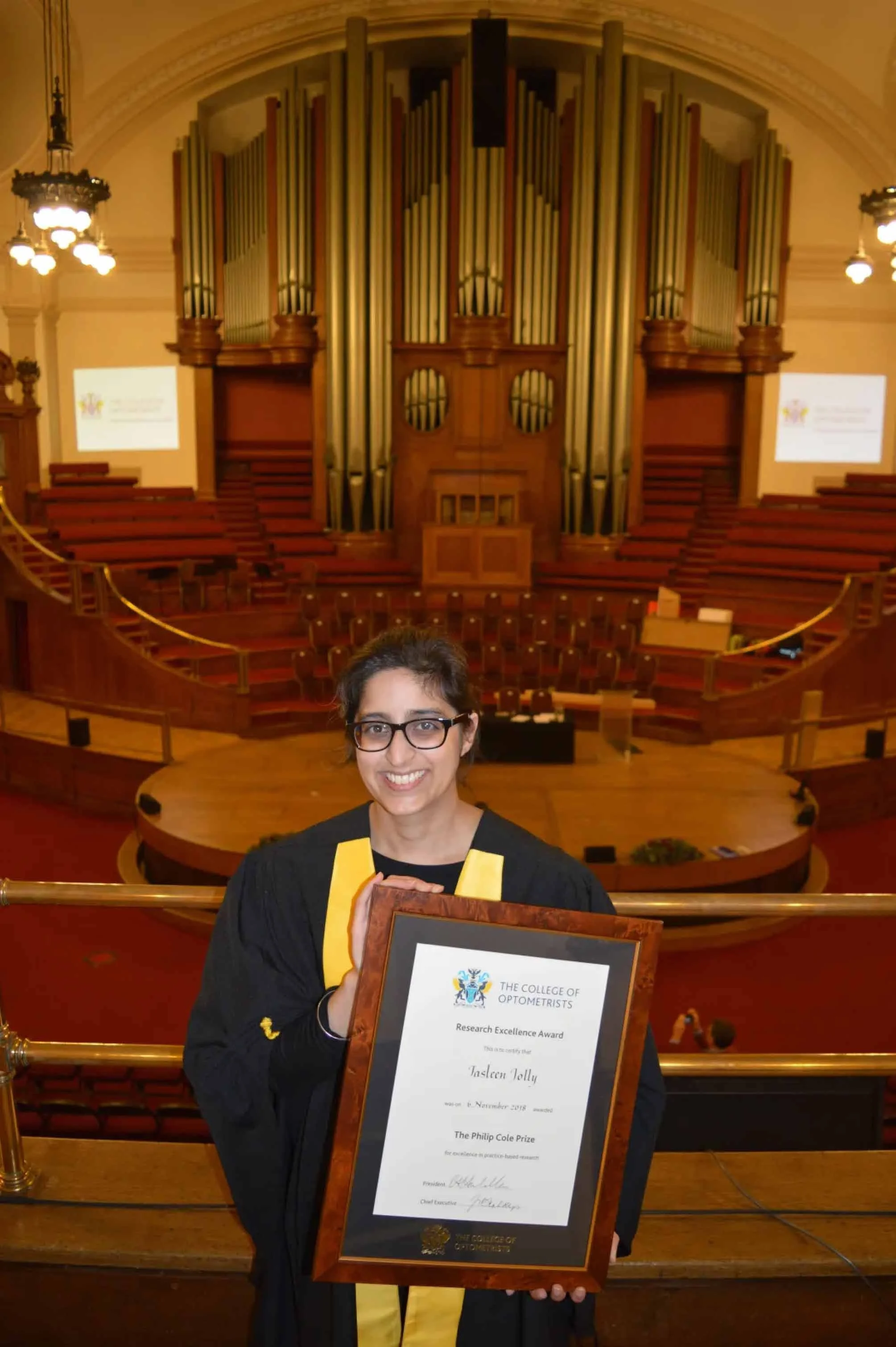 NADSN | National Association of Disabled Staff Networks | Dr. Jasleen K. Jolly Smiling at the Camera Holding an Award