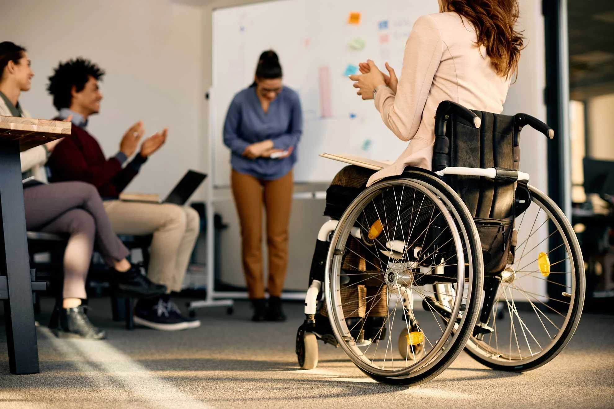 NADSN | National Association of Disabled Staff Networks | Wheelchair User Clapping During a Talk