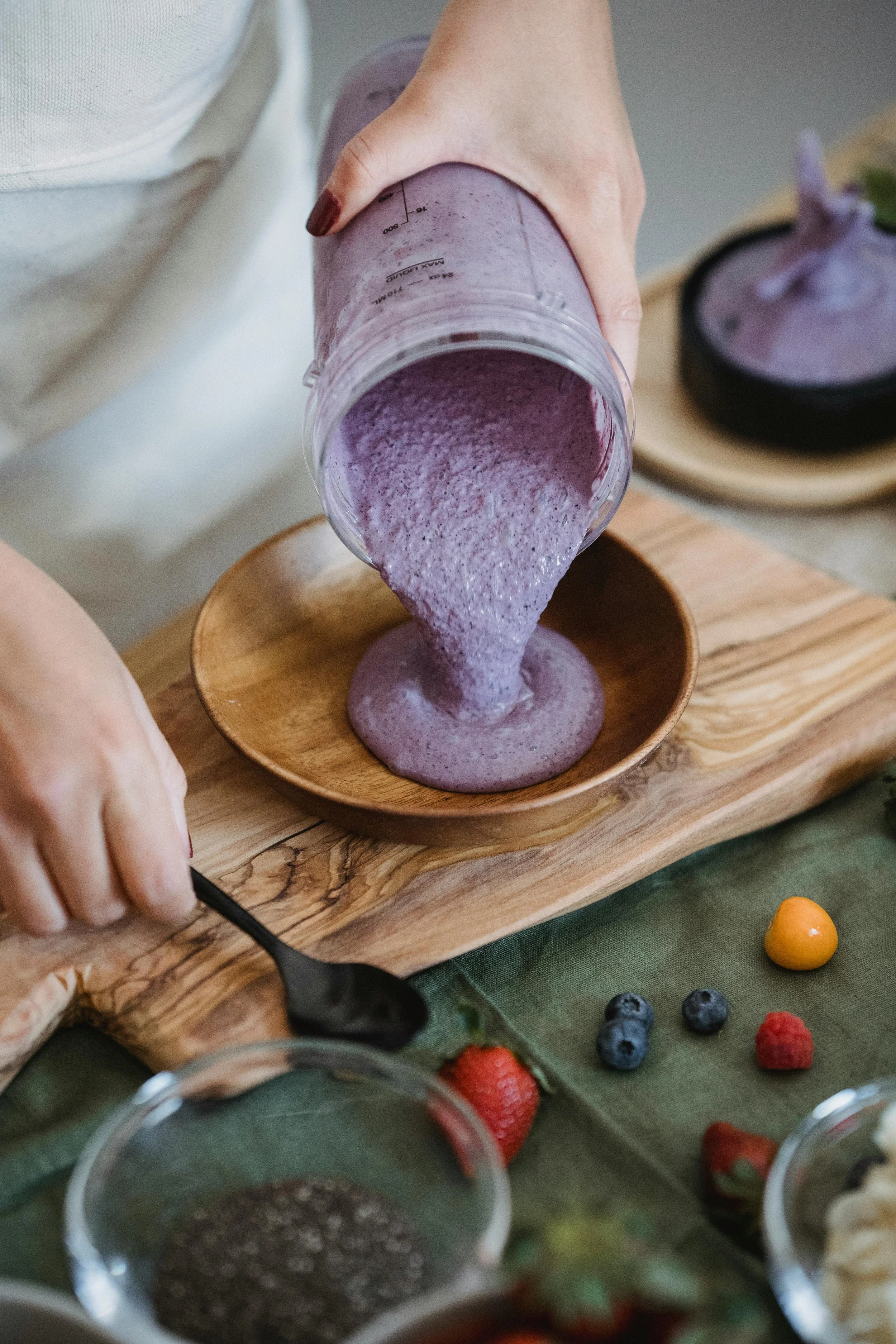 pouring a nutritious mix in a wooden bowl