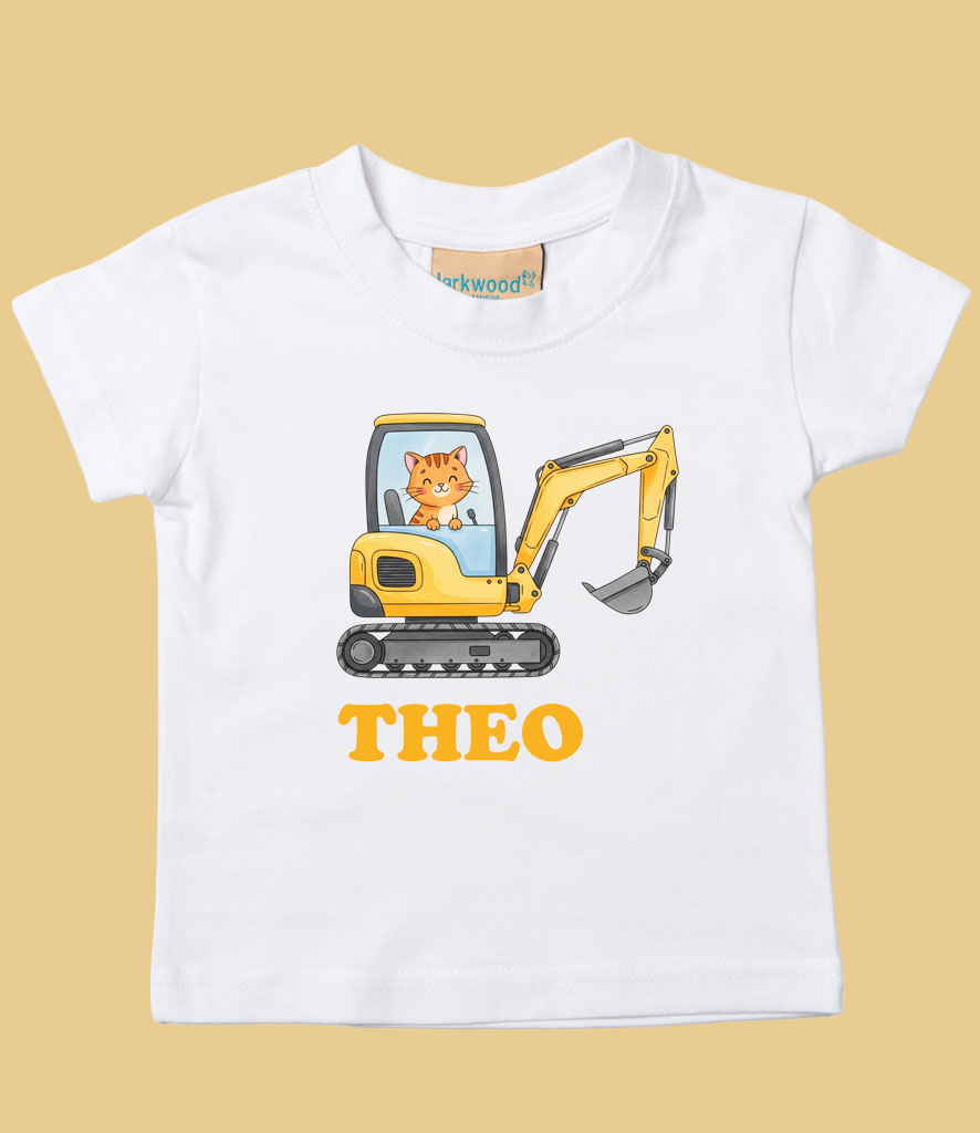 White child's t-shirt with a cartoon image of a cat operating a yellow excavator and the name 'Theo' in bold orange letters below.