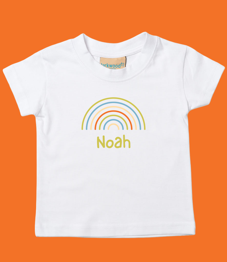 White T-shirt with a rainbow graphic and the name 'Noah' printed below it, against an orange background.