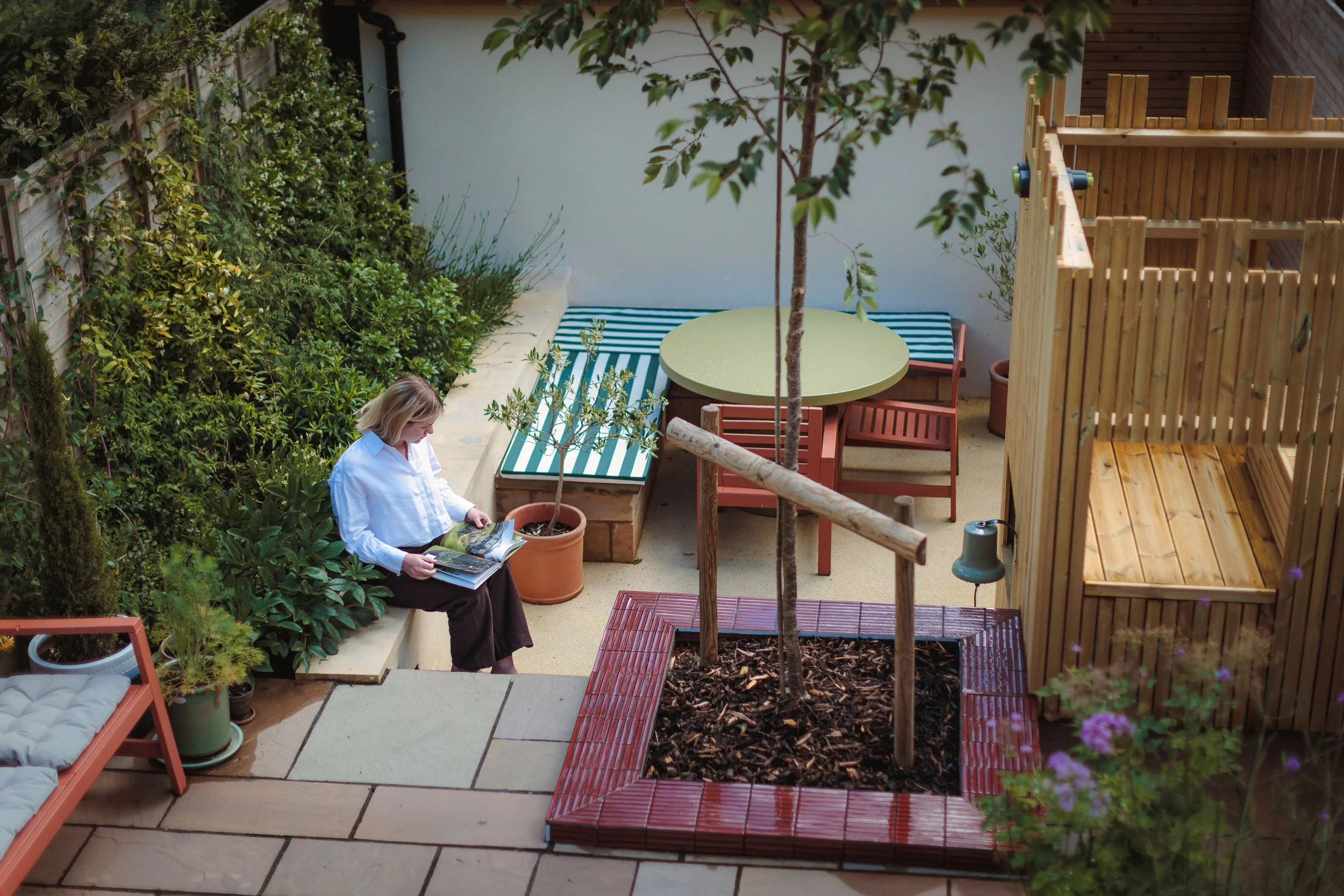 Looking down onto the garden from above. Using lovely bath stone copings as an extra spot to sit and read! Surrounded by the scents of the honeysuckle, phlox and jasmine