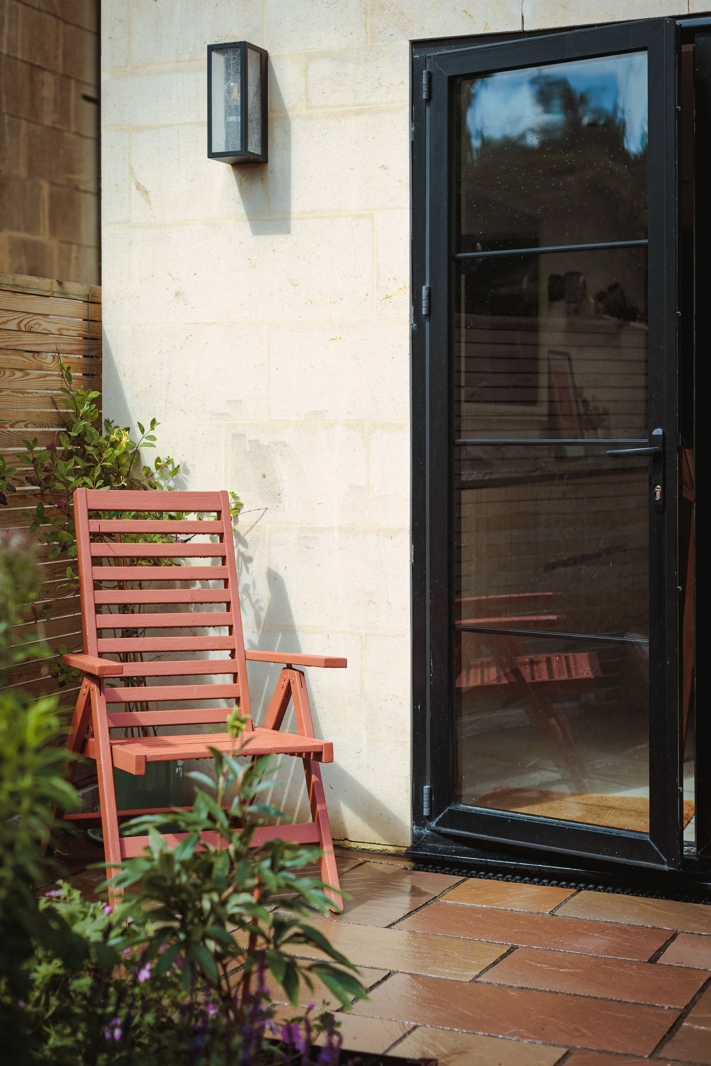 Space to sit just outside of the kitchen, for a quick morning coffee in the sun, or an after dinner read with the help of the wall light above