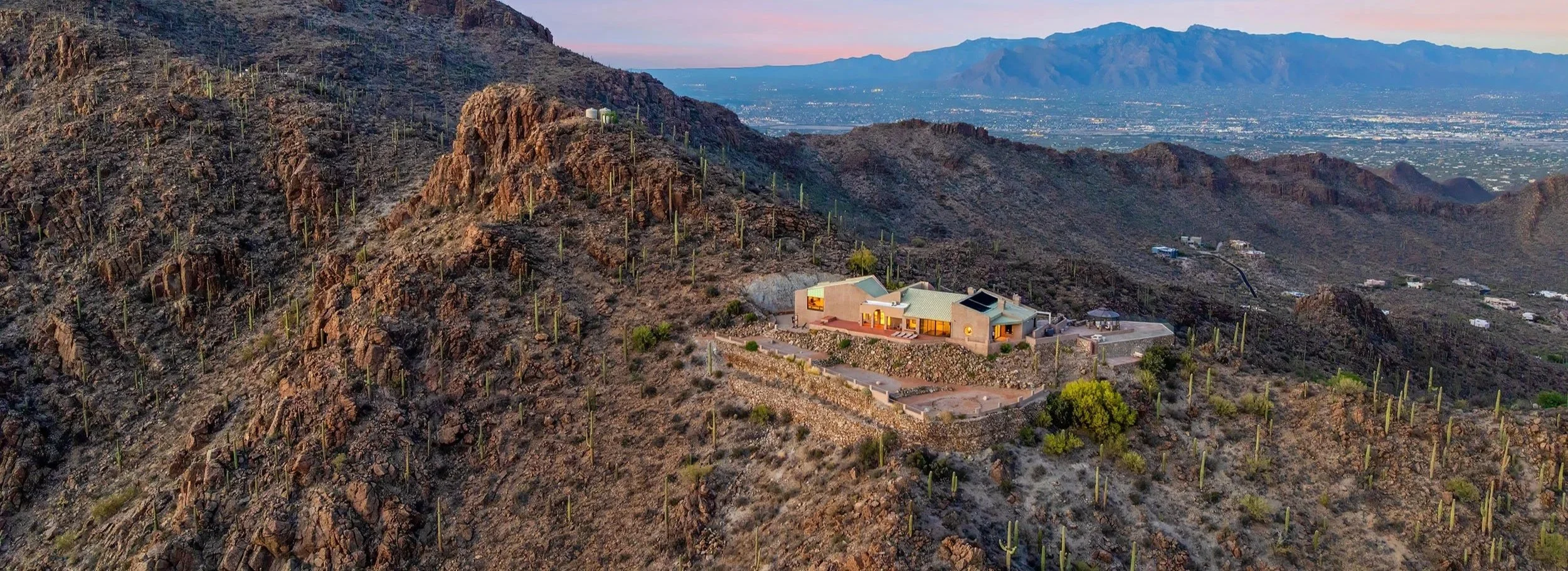 6931 W Sky Canyon Dr viewed from the west, showing its unique position on the crest of the Tucson Mountains.
