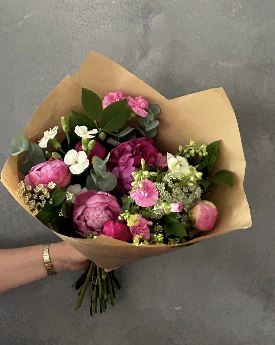 Gift bouquet with Peonies, Ammi and Dianthuswrapped in craft brown paper