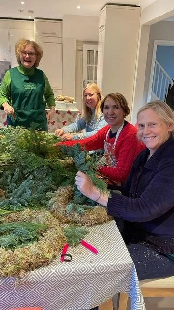 People at a Christmas wreath making workshop
