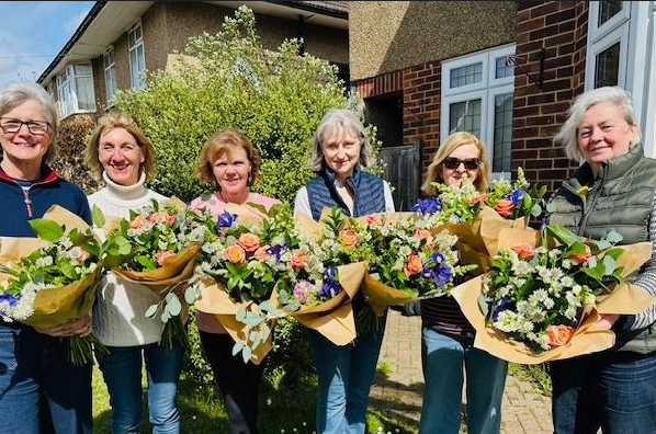ladies holding bouquets they have made