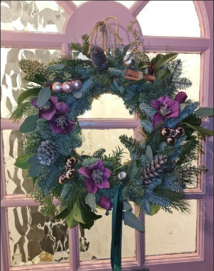Christmas wreath with purple flowers and pine cones