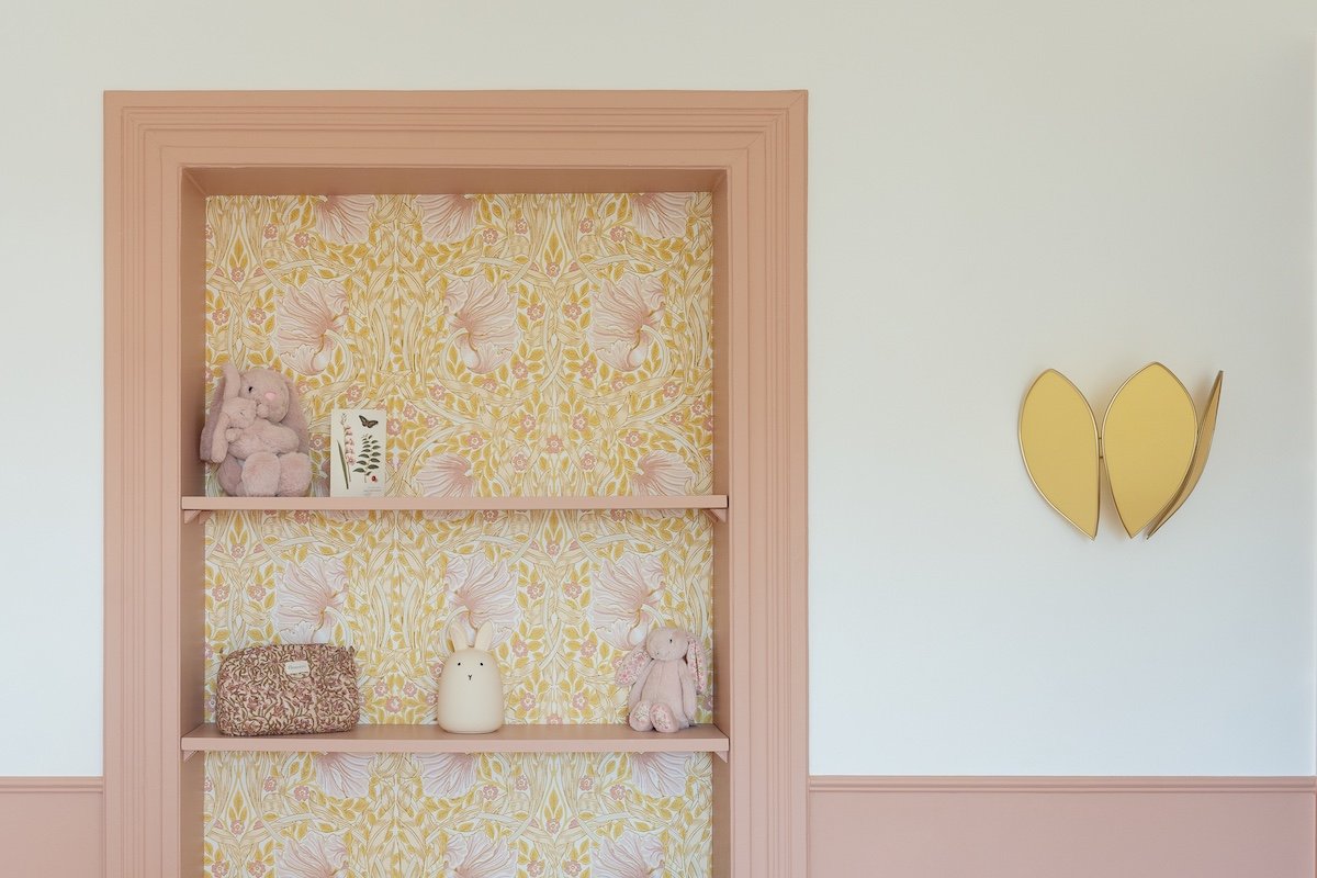 Photo d'une étagère rose avec un fond n motif jaune pour décoré une chambre d'enfant
