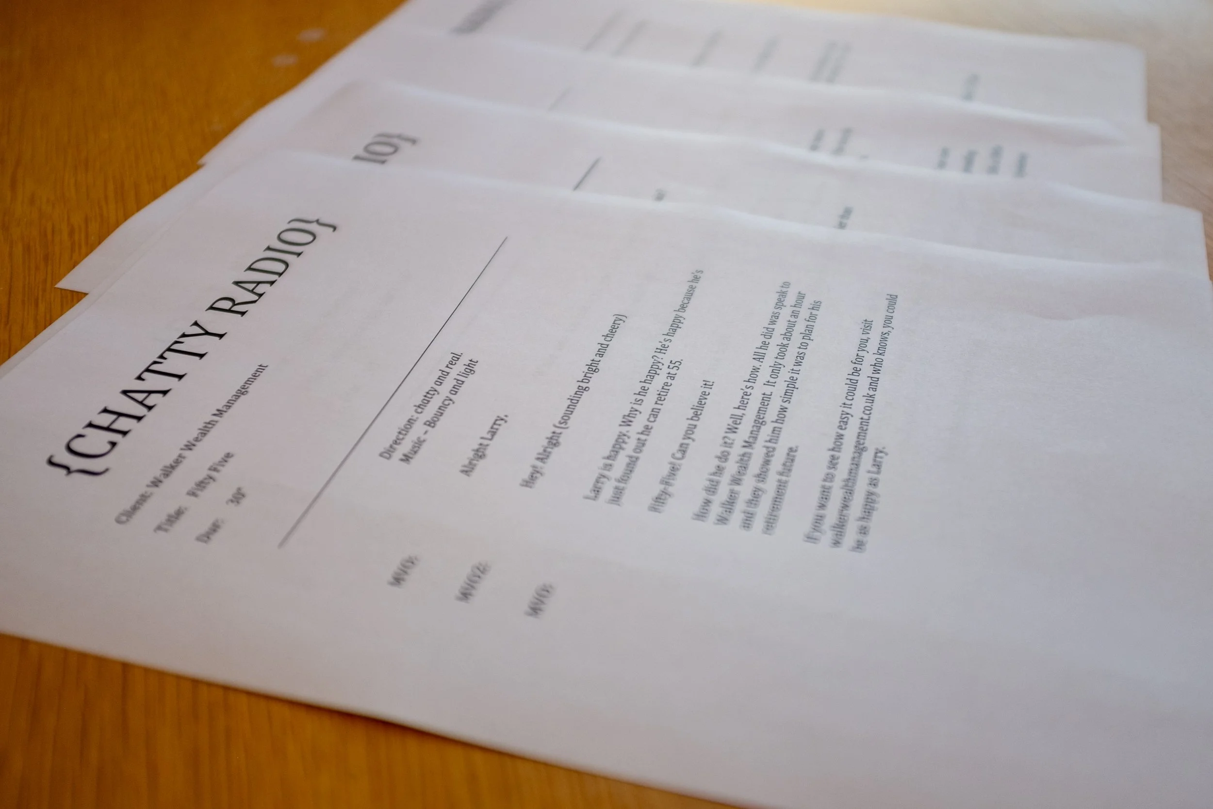 Pages of radio advertising scripts on a table