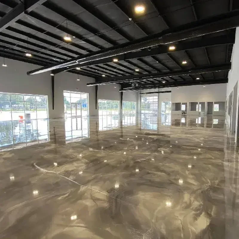 Empty commercial space with large windows, polished marble floors, black ceiling with exposed ductwork, and modern lighting.