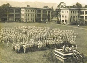 A crowd sitting in front of a person speaking.