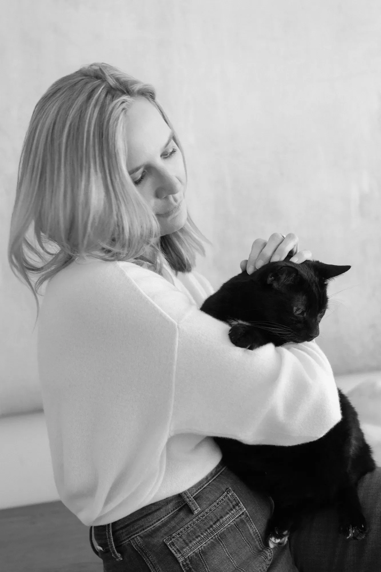 CT-based online therapist Jennifer Warpool pets her cat Harvey