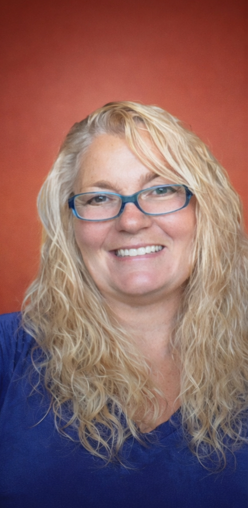 A grief therapy with curly blonde hair who works in Eugene, Salem, and Brookings Oregon providing Telehealth services.