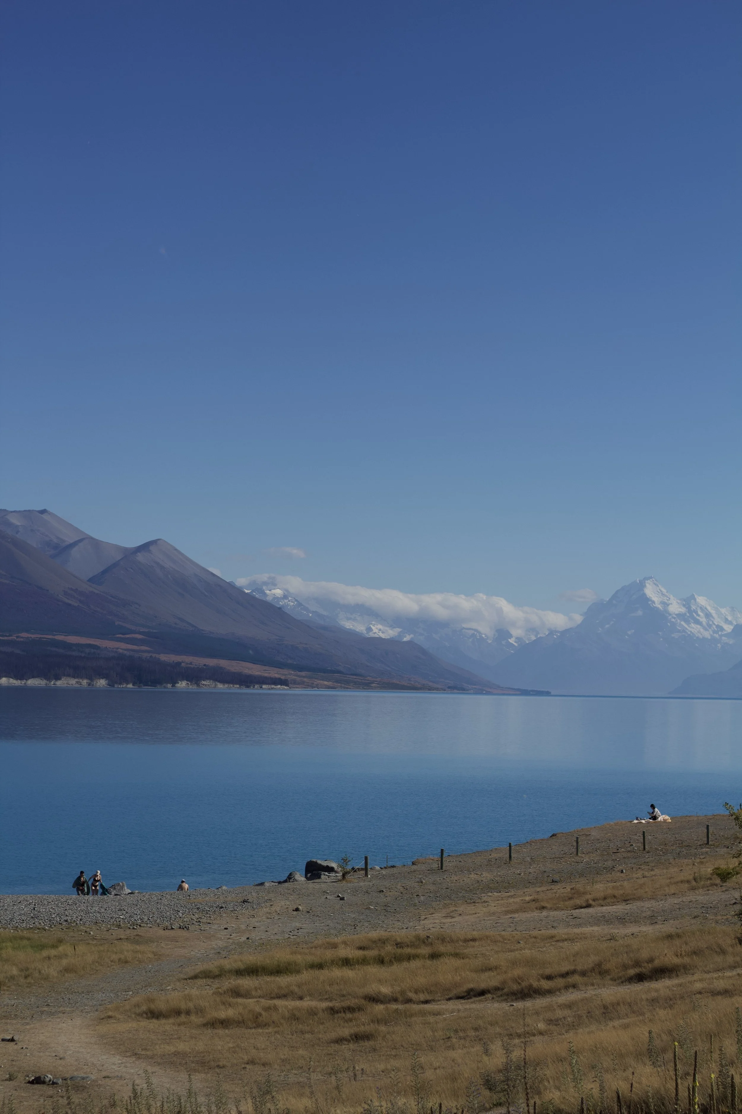 A scenic view of a large lake surrounded by mountains to match the calm therapy will help achieve.