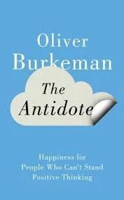 Book cover titled 'The Antidote' by Oliver Burkeman, featuring a light blue background and a white cloud with black text.