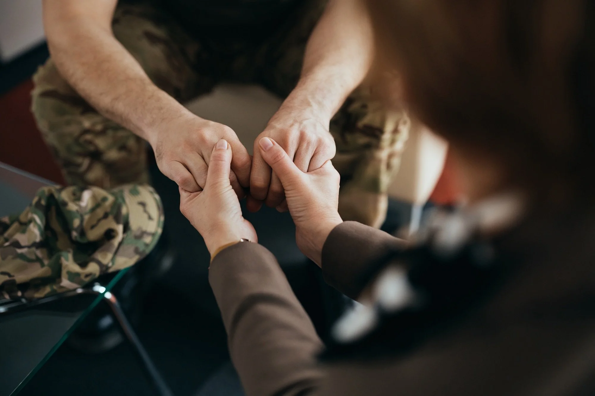 Multiple hands joined together in a show of unity or teamwork.
