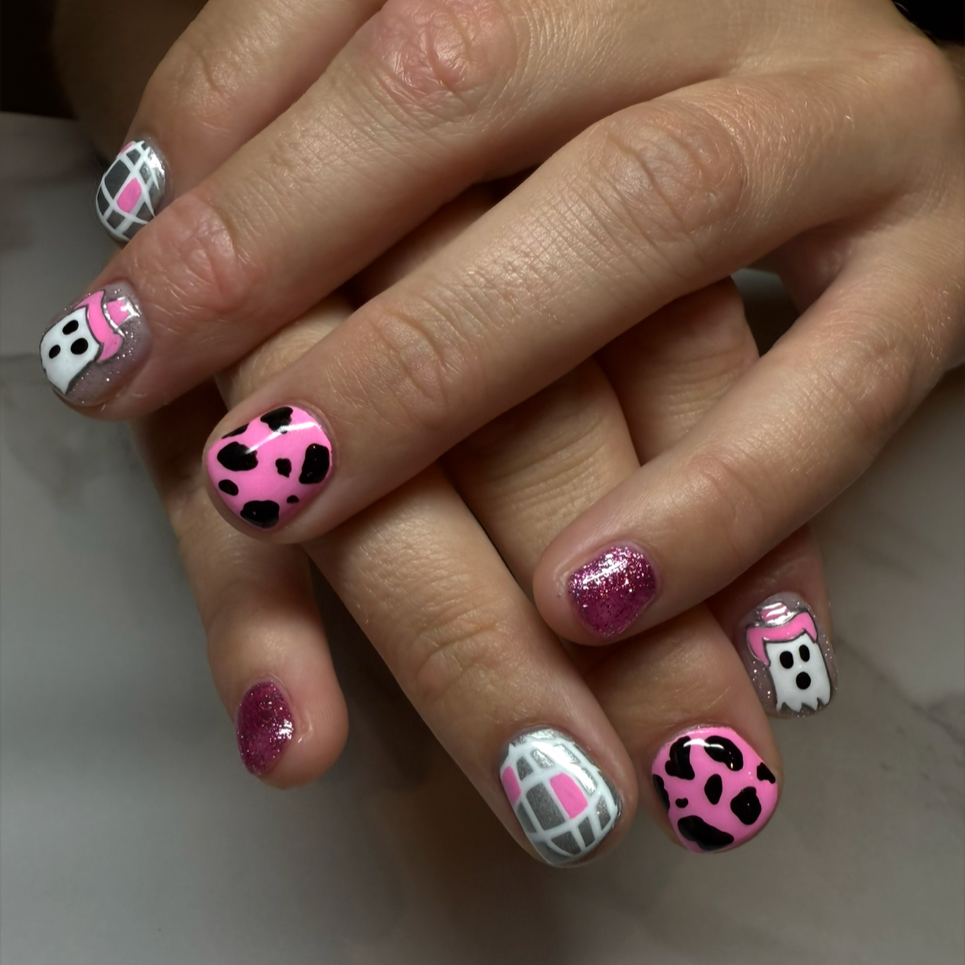 colorful, patterned nail polish designs on all fingernails, featuring pink, white, black, silver, and glitter accents by Salon 230 Daytona Beach