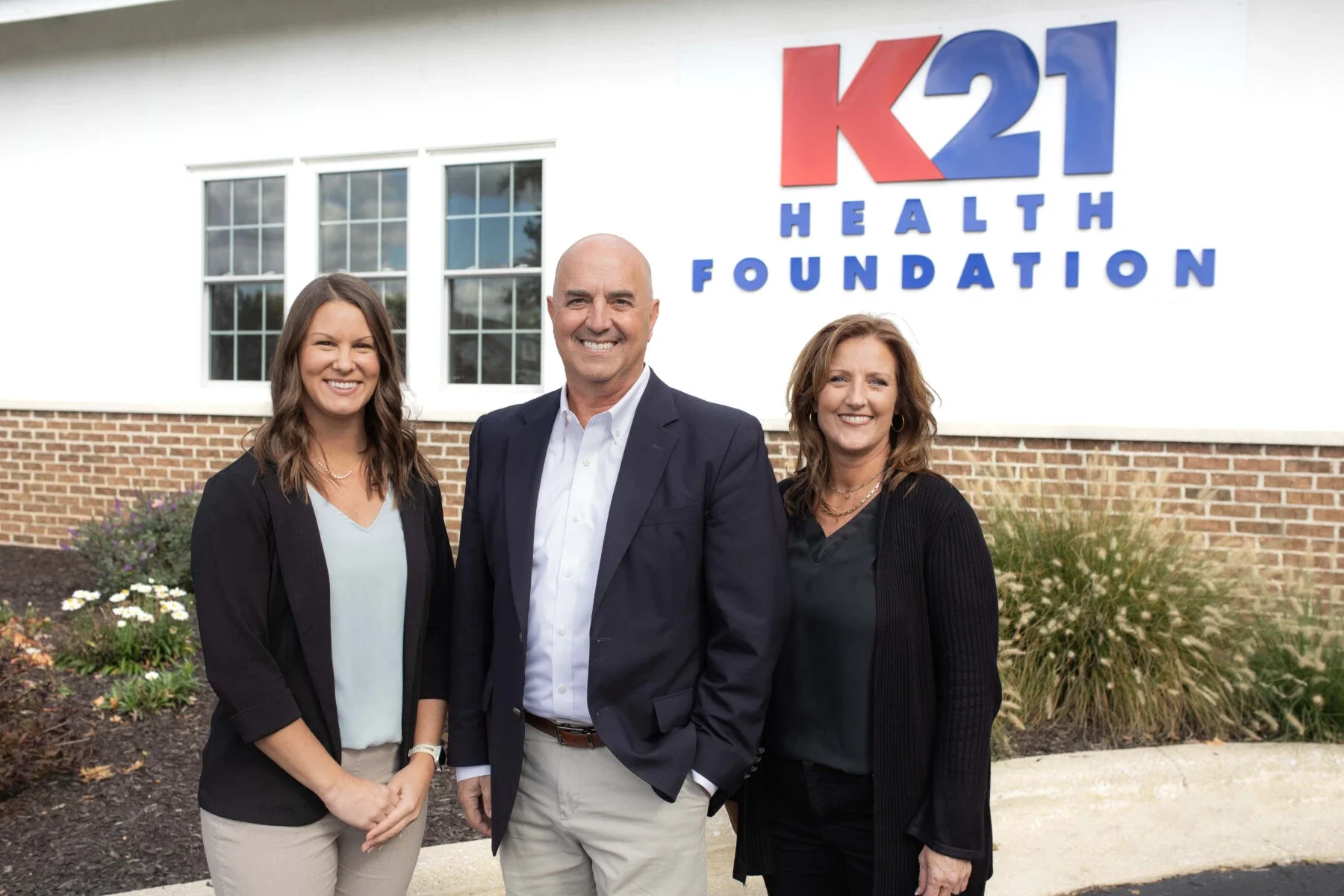 Group photo of K21 staff in front of their office