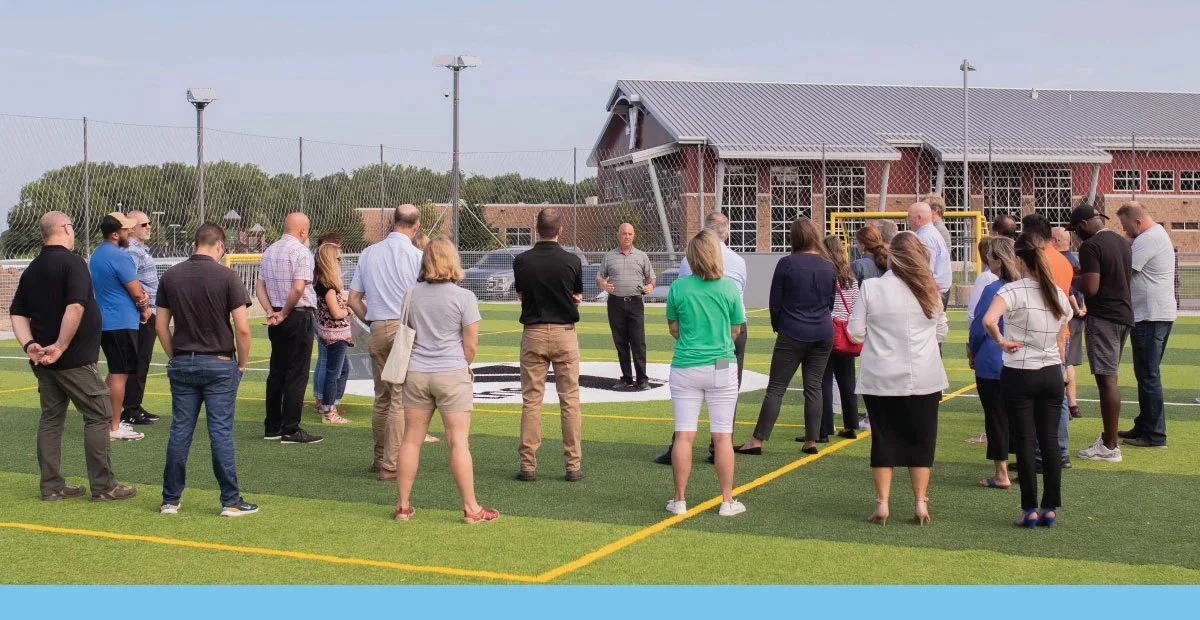 K21 staff presenting to a group at the YMCA soccer fields