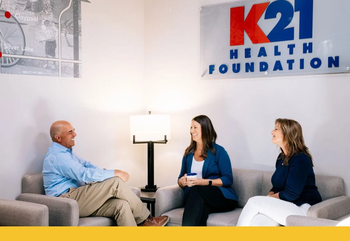 K21 staff seated in their office